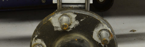 Close-up of trailer wheel hub and studs during maintenance
