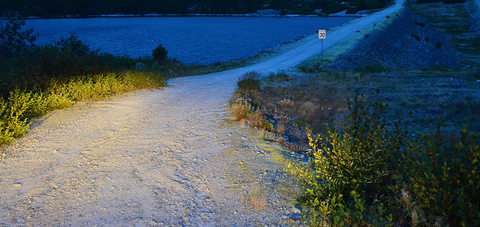 Rough gravel road beside water